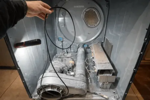 Samsung dryer disassembled during repair in a laundry room in Las Vegas showing drum housing, blower assembly and internal components