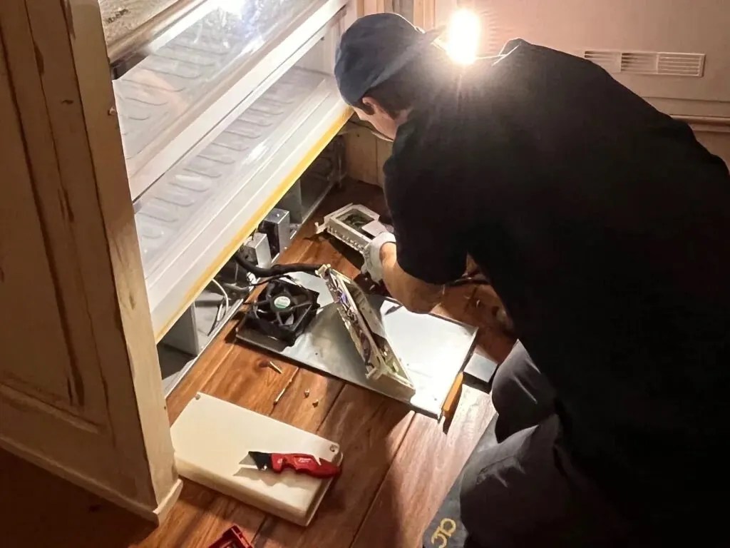Technician installing OEM control boards in a Miele refrigerator in Las Vegas