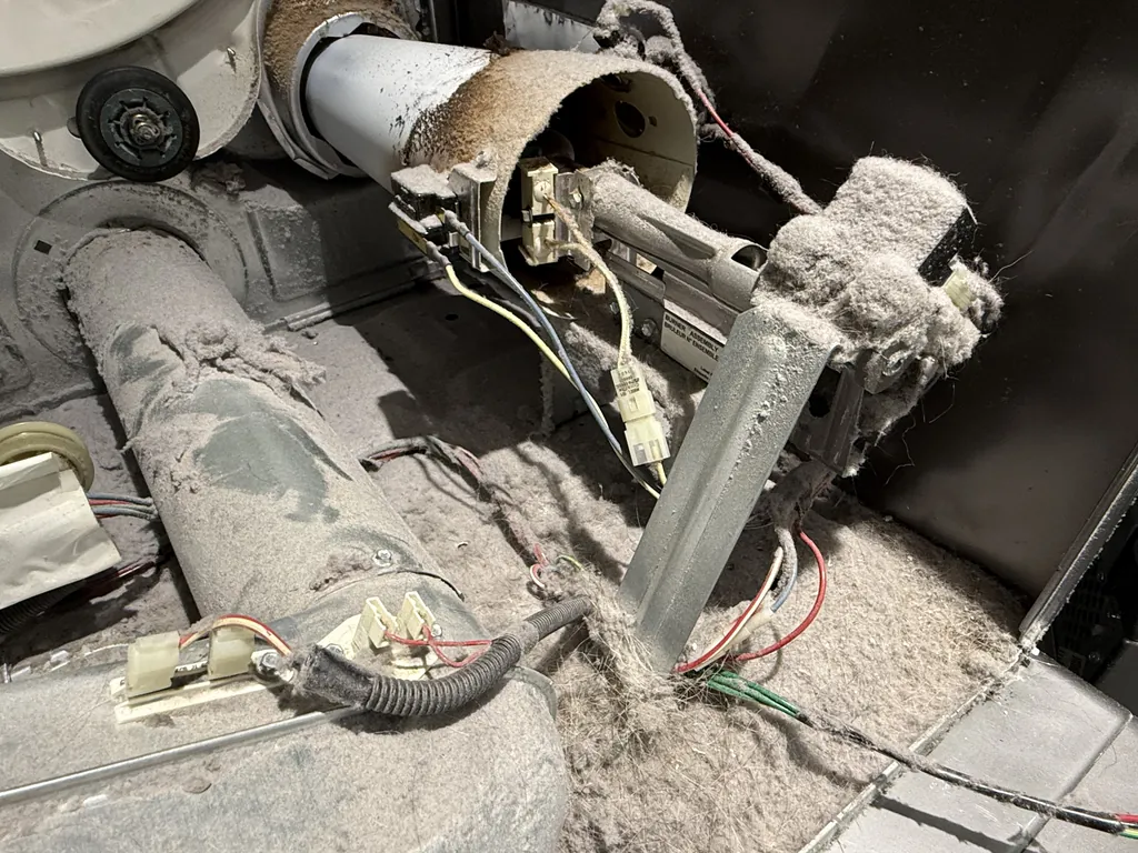 Dryer heating element and wiring covered in lint, a fire hazard
