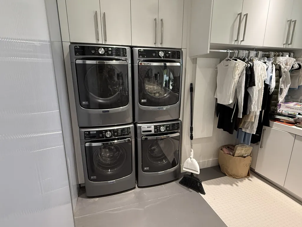 Two stacked Maytag washer and dryer pairs in a Henderson laundry room after dryer repair