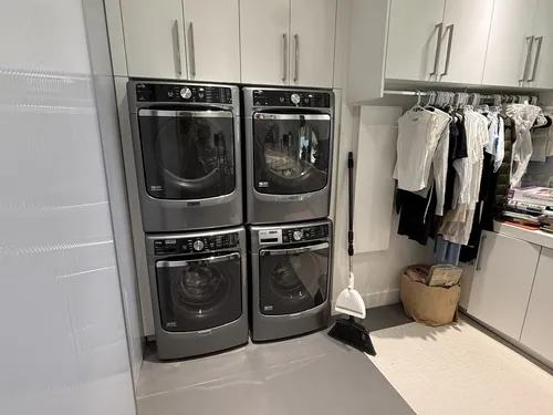 Two stacked Maytag washer and dryer pairs in a Henderson laundry room after dryer repair