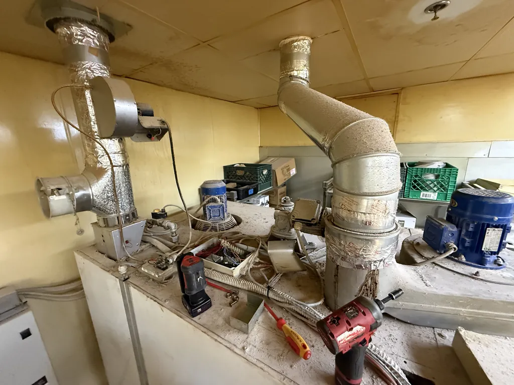 Top of a Polin rotating rack oven with flue and exhaust ducts opened for service
